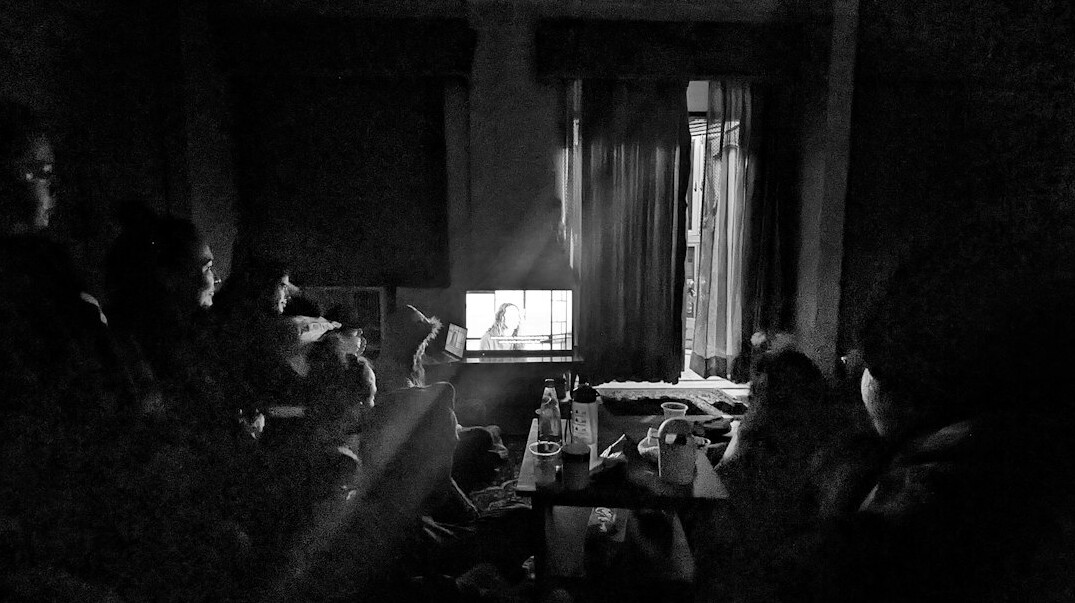 group of fans watching old tv